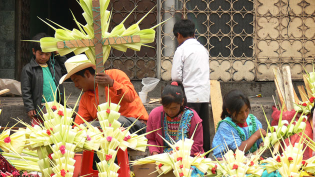 A Mayan man and children make traditional crosses.